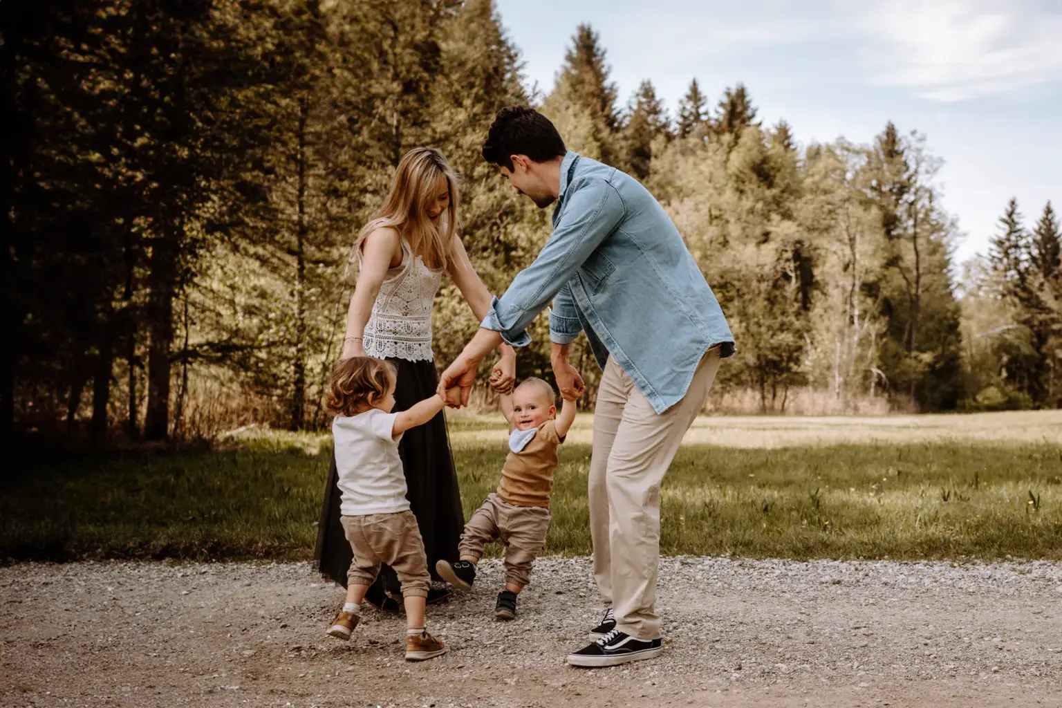 Familienfoto auf einer Wiese, viel Weite, natürliche Farben und echtes Lachen