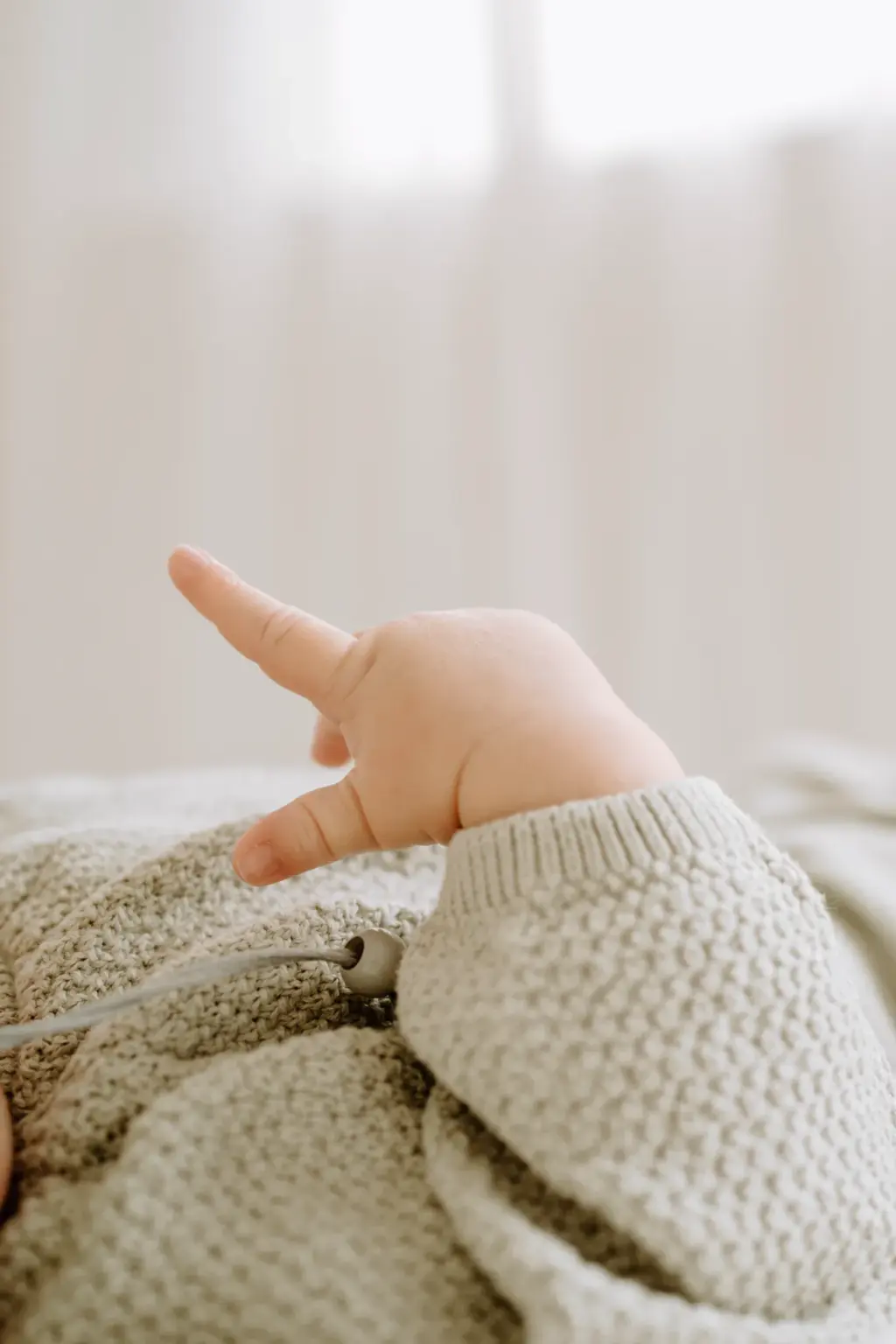 Detailfoto von einem Babyfinger im Hochformat